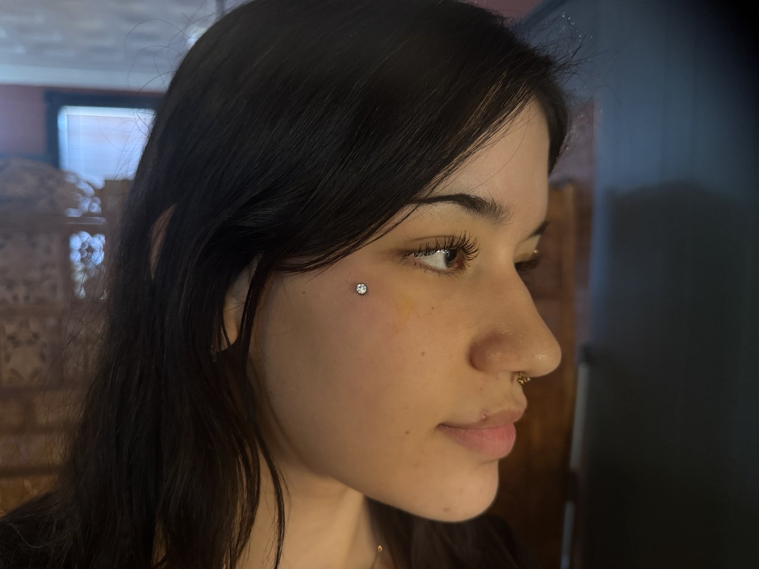 Dermal teardrop piercing by Illustrated Alex